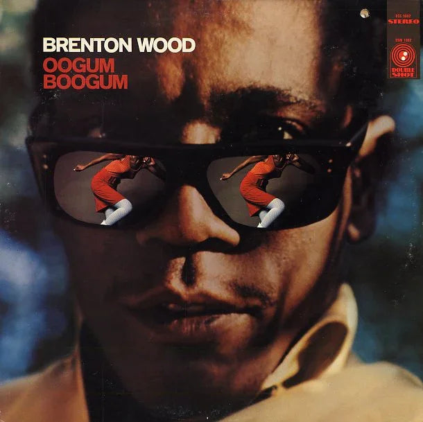 Close-up of Brenton Wood's face with Oogum Boogum album title, woman dancing reflected in sunglasses