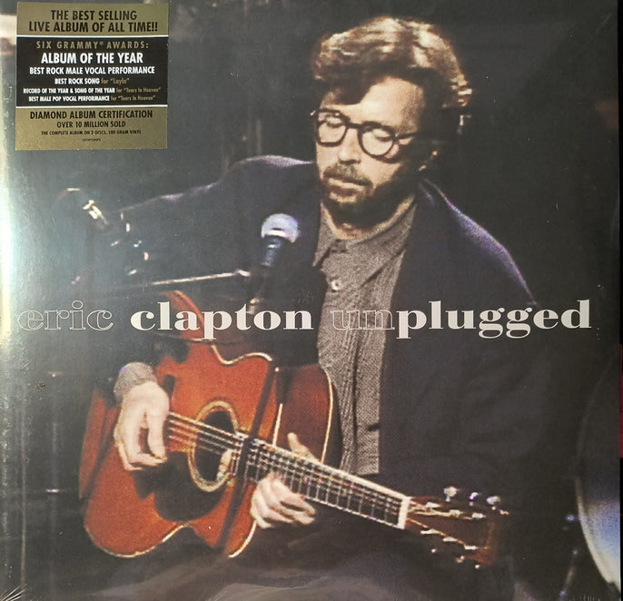 Unplugged vinyl record cover featuring a musician playing acoustic guitar on stage.