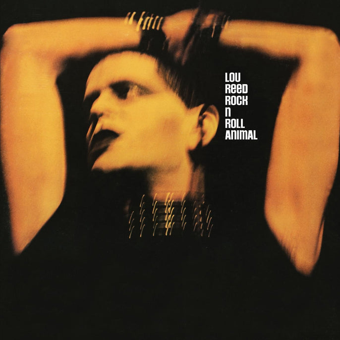Blurry close-up of person with arms raised, dark background, Lou Reed Rock n Roll Animal album cover