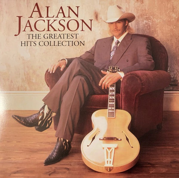 Country music vinyl record cover featuring a man in a suit and cowboy hat with a guitar.
