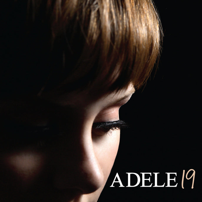 Close-up portrait on a dark background with the text 'ADELE 19' in the corner, vinyl album cover.