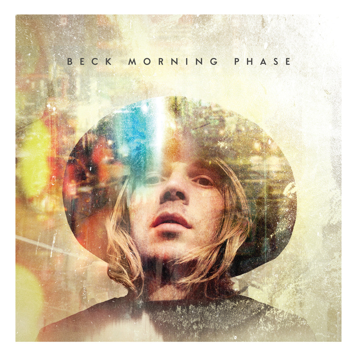 Album cover for Beck's "Morning Phase," featuring a close-up of a person with long hair and a wide-brimmed hat, overlaid with a blurred, dreamy light effect.