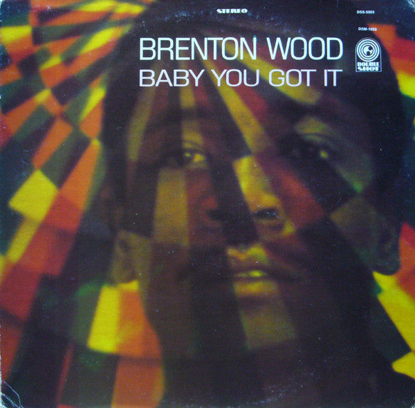 Album cover for "Baby You Got It" by Brenton Wood, featuring his face partially overlaid with colorful, geometric light patterns.