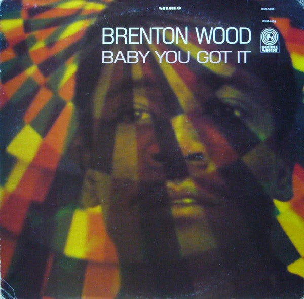 Album cover for "Baby You Got It" by Brenton Wood, featuring his face partially overlaid with colorful, geometric light patterns.
