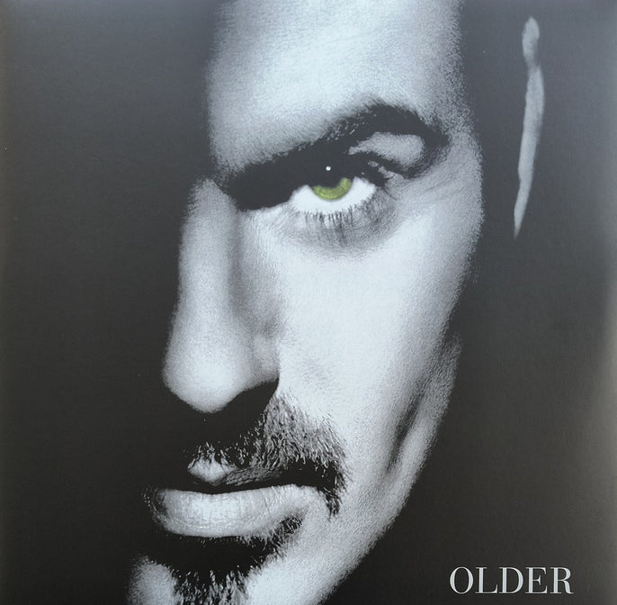 Black and white close-up of a man's face with green eye and the word 'OLDER' at the bottom.