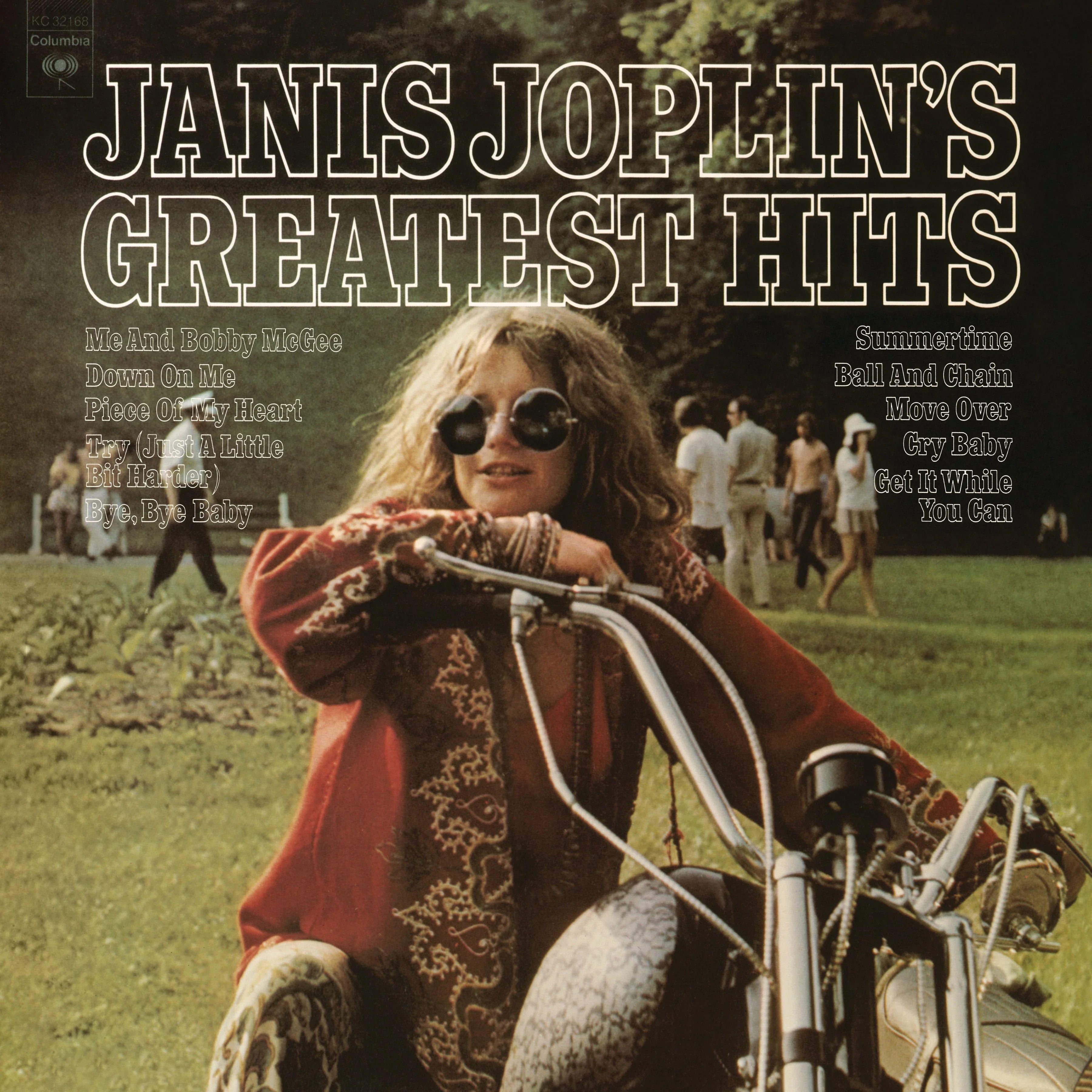 Janis Joplin sits on a motorcycle in a park, wearing sunglasses and patterned clothes, with the text "Janis Joplin's Greatest Hits" and a song list above her.