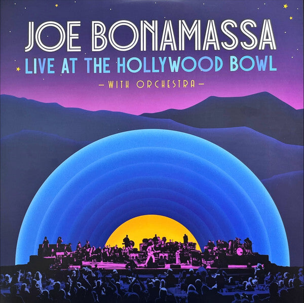 Poster for "Joe Bonamassa Live at the Hollywood Bowl with Orchestra" featuring a stylized stage, audience, and mountains in purple, blue, and yellow tones.