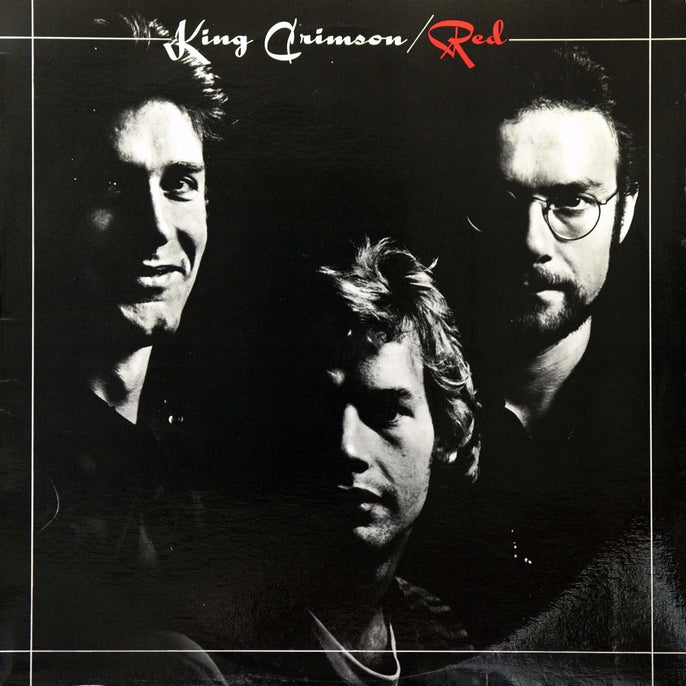 King Crimson Red album cover with black and white band portrait and stylized red text.