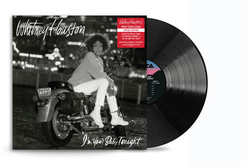 Vinyl record of Whitney Houston's I'm Your Baby Tonight album with cover photo of her on a motorcycle.