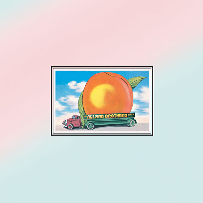 Eat a Peach album cover with illustrated peach on truck, blue sky background, classic rock vinyl