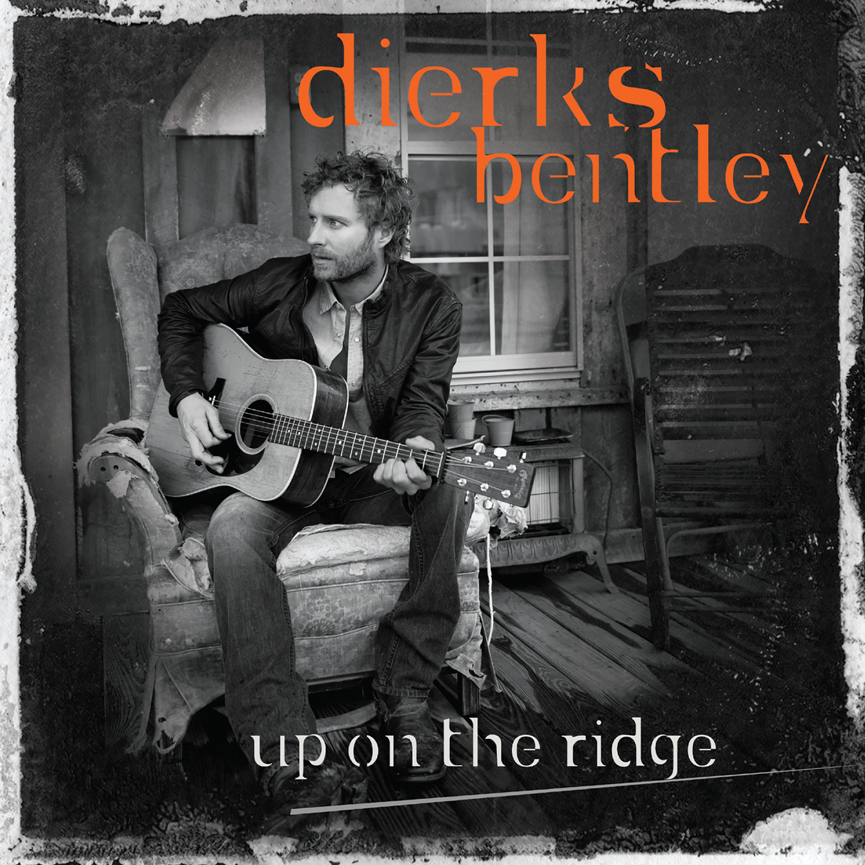 A man sits on a porch playing an acoustic guitar; album cover text reads "dierks bentley up on the ridge.