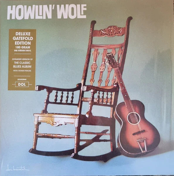 Two ornately carved wooden rocking chairs and an acoustic guitar are displayed against a plain background on the cover of a Howlin' Wolf deluxe vinyl album.