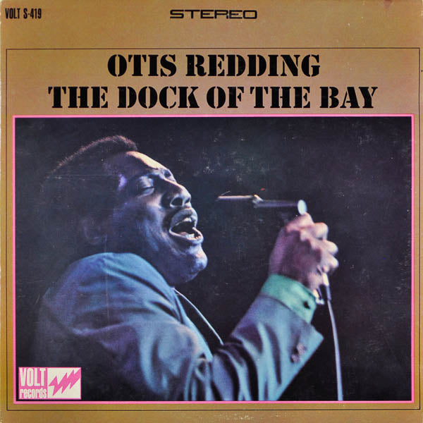 Album cover for "The Dock of the Bay" by Otis Redding, showing Otis singing passionately into a microphone with a brown and pink border.