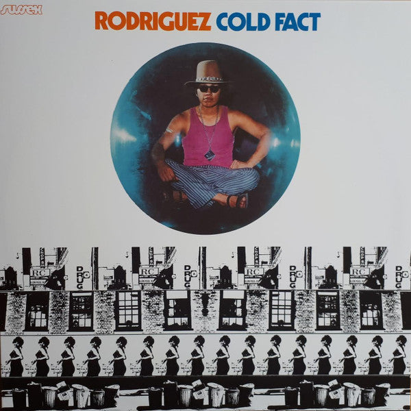 Album cover for "Cold Fact" by Rodriguez, featuring Rodriguez sitting cross-legged inside a blue circle above a black-and-white graphic of repeating buildings and walking figures.