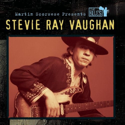 Stevie Ray Vaughan poses with an electric guitar, wearing a wide-brimmed hat and embroidered jacket. Text above reads "Martin Scorsese Presents The Blues: Stevie Ray Vaughan.