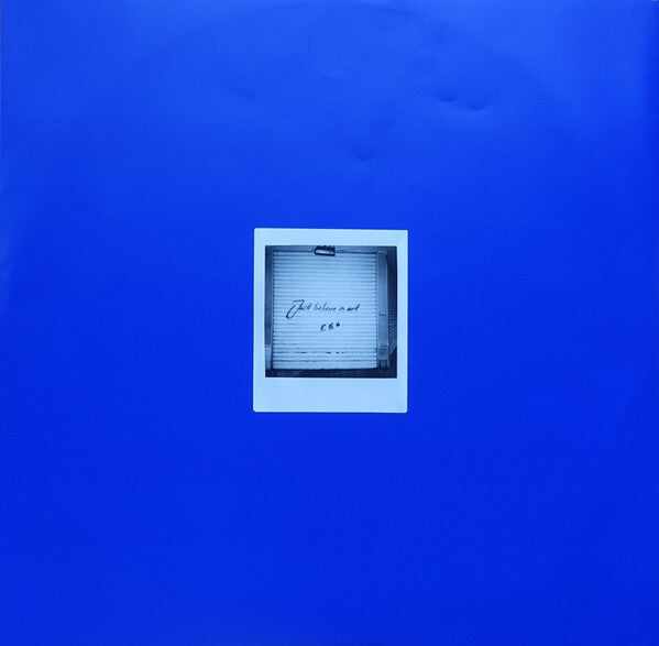 Blue vinyl album cover with a centered black and white polaroid photograph.