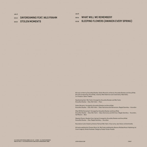 Minimalist vinyl record back cover listing track titles such as Daydreaming feat. Nils Frahm, Stolen Moments, What Will We Remember, and Sleeping Flowers, with credits on a beige background.