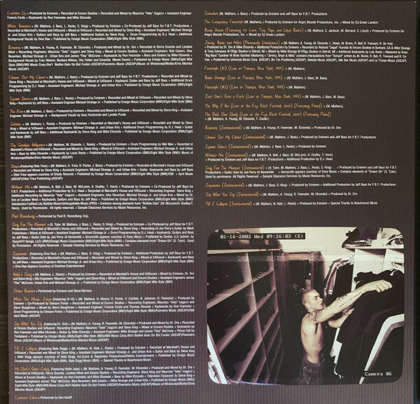 Vinyl record album credits and tracklist with a small photo of a man organizing shelves.