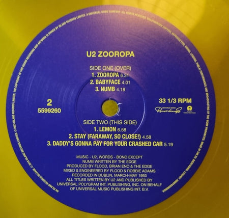 U2 Zooropa vinyl record label with tracklist on yellow vinyl, classic rock music collectible.