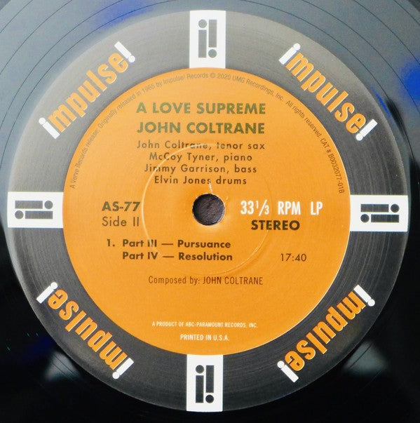A Love Supreme John Coltrane vinyl record, Impulse! label, jazz album close-up.