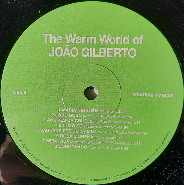 Close-up of The Warm World of João Gilberto vinyl record label, green background, tracklist visible.
