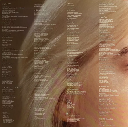 Close-up of vinyl record album insert featuring song lyrics overlaid on a woman's face with light blonde hair.