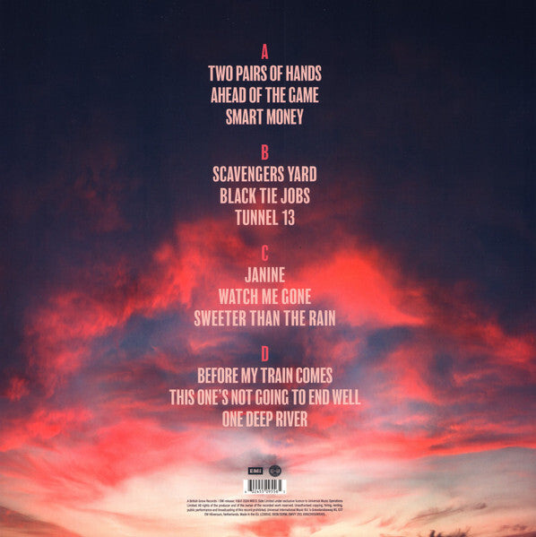 Vinyl record back cover with tracklist and vibrant red-orange sunset sky background.