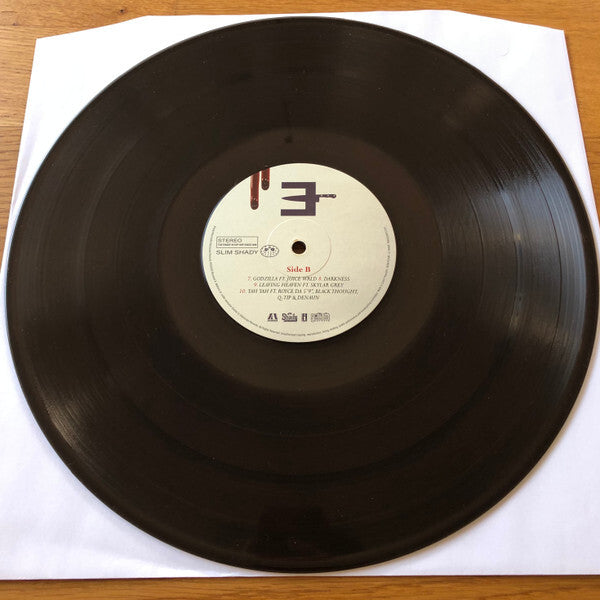 Classic vinyl record on paper sleeve featuring Side B tracklist and a white label design
