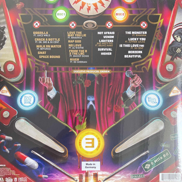 Colorful pinball machine design featuring hands holding microphones, album song list, and vibrant lights