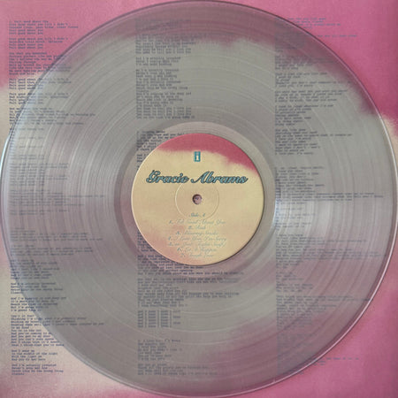 Clear vinyl record with Gracie Abrams label on pink lyric sheet background