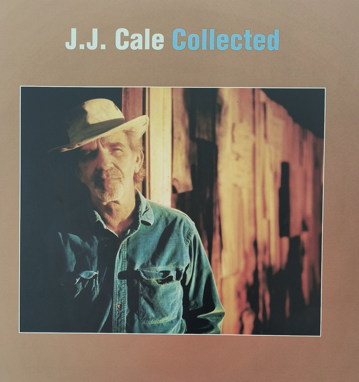 J.J. Cale Collected vinyl album cover featuring artist in denim shirt and hat, rustic wood background