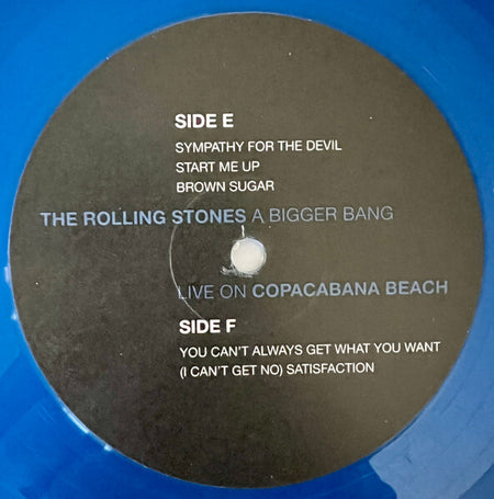 Blue vinyl record label, The Rolling Stones A Bigger Bang Live on Copacabana Beach, tracklist visible.