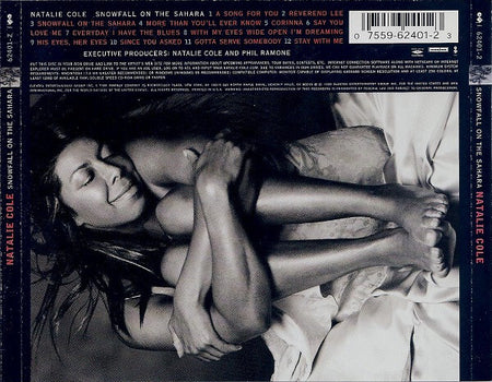 Smiling woman laying on bed in black and white, album tracklist and barcode visible, music cover.