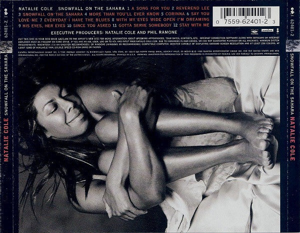 Smiling woman laying on bed in black and white, album tracklist and barcode visible, music cover.