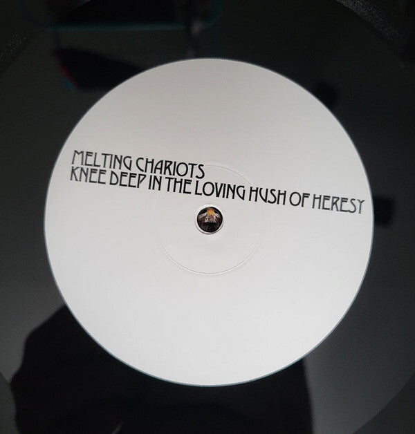 Close-up of Melting Chariots vinyl record label, minimalist white design, music collectors