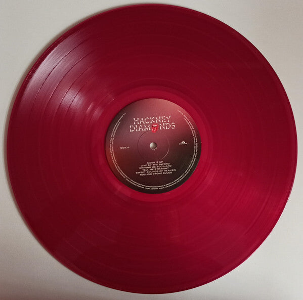 Red Hackney Diamonds vinyl record on white background, music collector edition