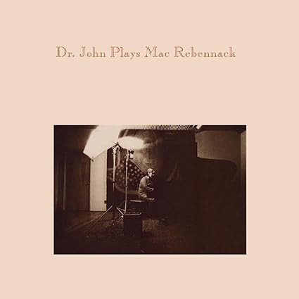 Vinyl record cover with sepia-toned photo of man at piano and text Dr. John Plays Mac Rebennack.