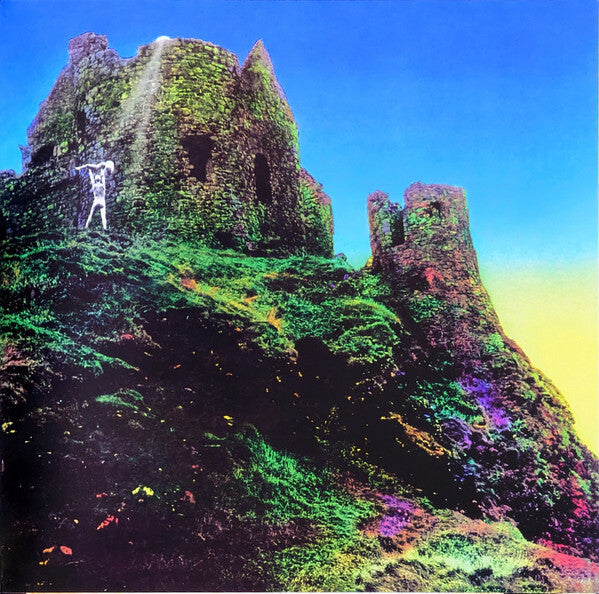 Psychedelic vinyl album cover with vibrant ruins on a grassy hill and a lone figure in white