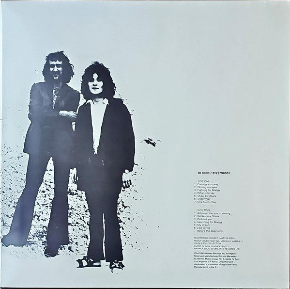 Monochrome vinyl record cover with two men standing, tracklist printed on white background.