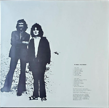 Monochrome vinyl record cover with two men standing, tracklist printed on white background.