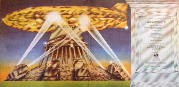Vinyl record album artwork with golden airship, beams of light over ancient monument, and song list.