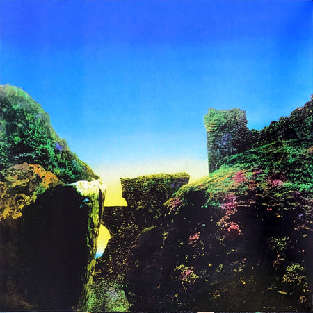 Vivid album cover with ancient stone ruins and mossy green landscape under a bright blue sky