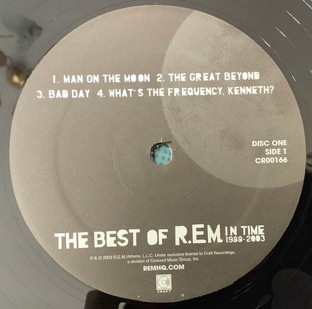 Close-up of The Best of R.E.M. In Time 1988-2003 vinyl record, Side 1 tracklist label.
