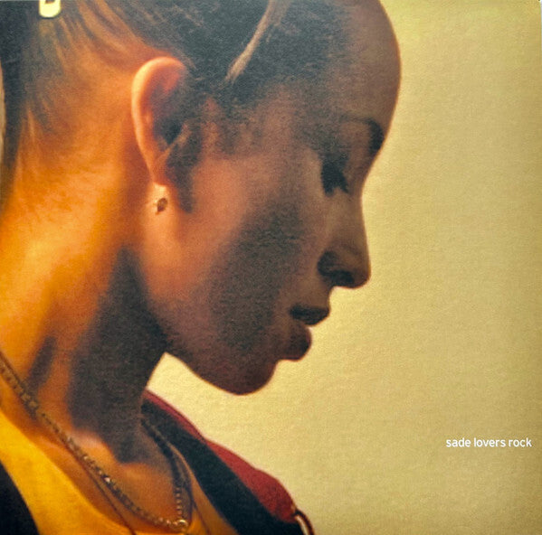 Sade Lovers Rock vinyl record cover featuring a side profile portrait of a woman in soft light.