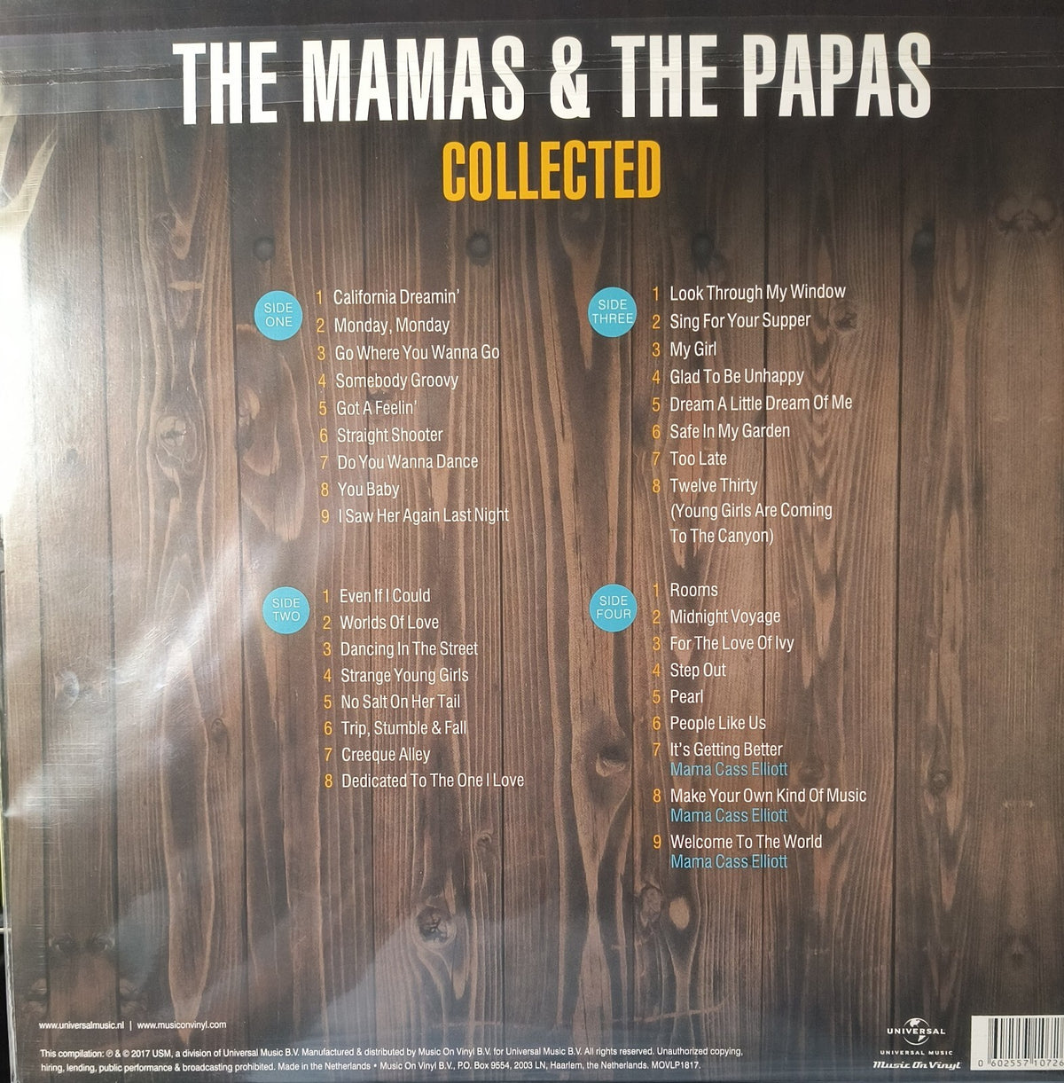 Back cover of The Mamas & The Papas Collected vinyl album showing tracklist on wood background