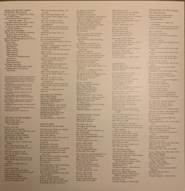 Vinyl record album inner sleeve with printed song lyrics, tracklist, and credits in columns.