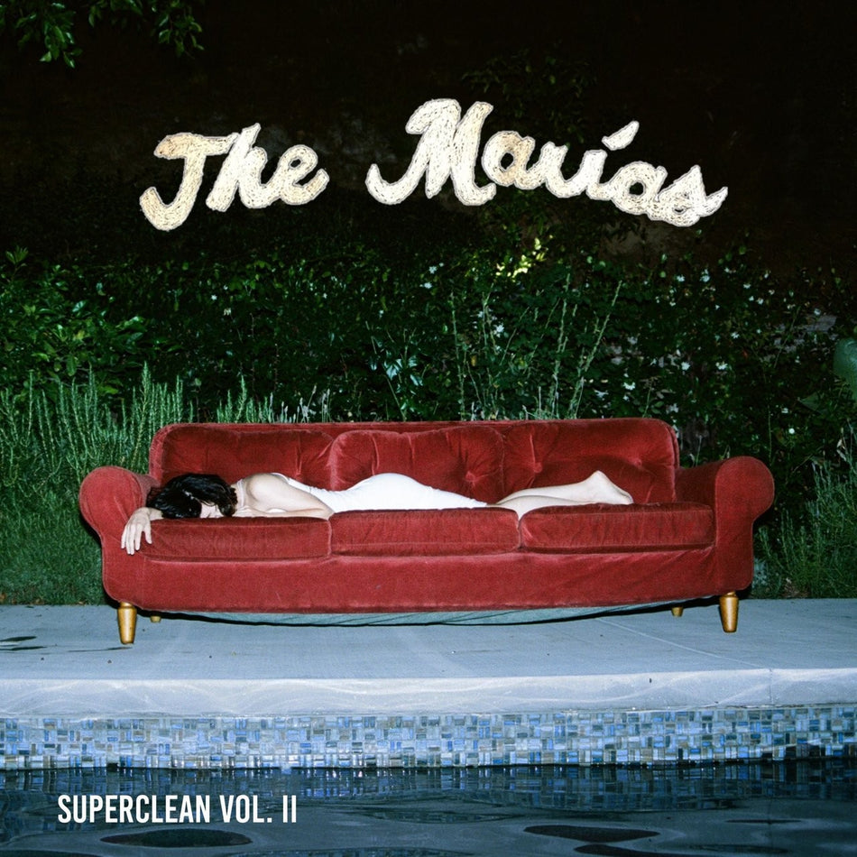 The Marías Superclean Vol. II album cover showing a person in white dress lying on a red sofa by a pool at night.