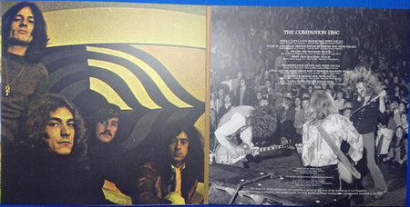 Vintage vinyl record gatefold with classic rock band photo and live concert crowd scene