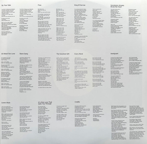 Vinyl record inner sleeve with printed song lyrics, track titles, and credits on a light background.