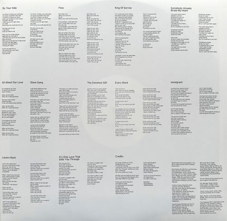 Vinyl record inner sleeve with printed song lyrics, track titles, and credits on a light background.